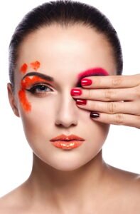High fashion look.glamor closeup portrait of beautiful sexy brunette young woman model with orange lips,bright unusual creative plastic makeup, with perfect clean skin with colorful nails isolated on white